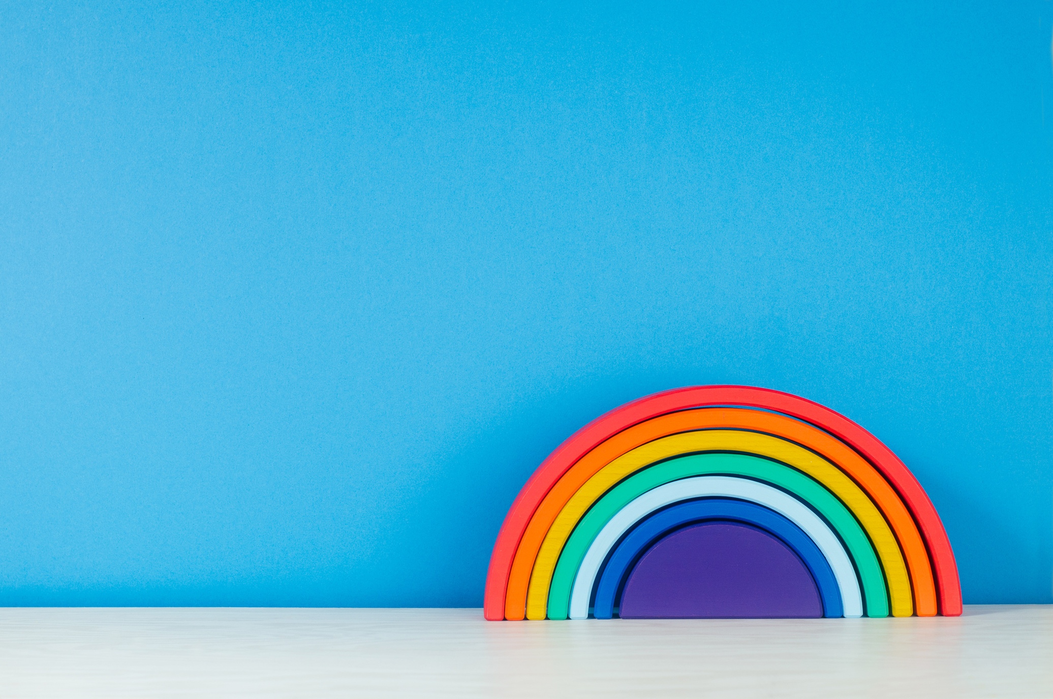 Wooden toy rainbow on the shelf in the kids room
